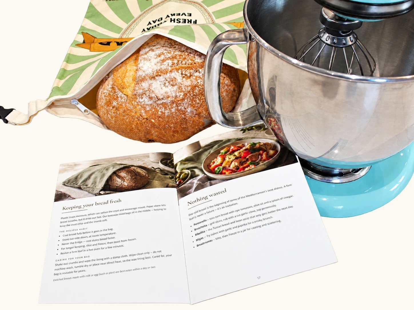 A round sourdough loaf inside an open Melipsa bread bag, next to the recipe book